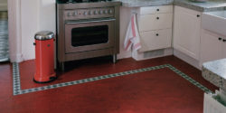 Red marmoleum kitchen flooring with green border pattern