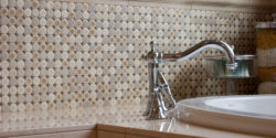 Circular pattern ceramic tile backsplash behind bathtub