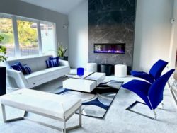 modern fireplace with a white sectional and and a blue couch