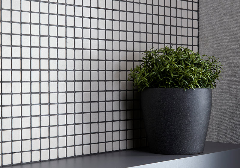 This small-scale square tile highlights how important the grout color is to the design.