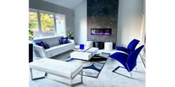 modern fireplace with a white sectional and and a blue couch